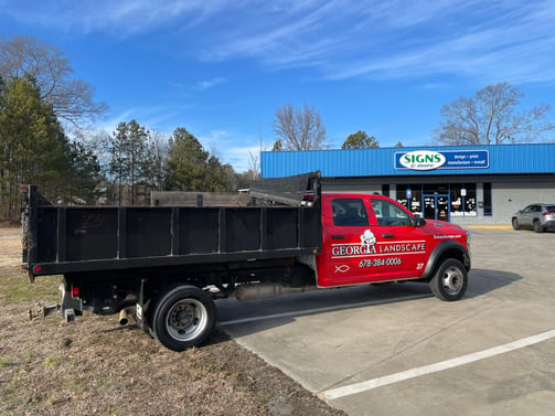 White Landscape Company Dump Truck Cab Wrapped to Red with Logos